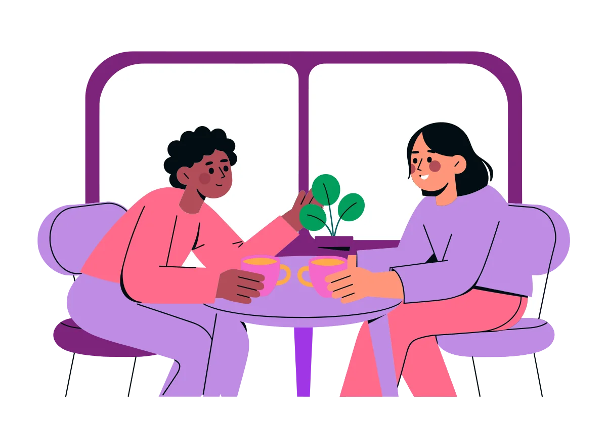A couple at a kitchen table with two mugs of tea, one talking gently while the other listens