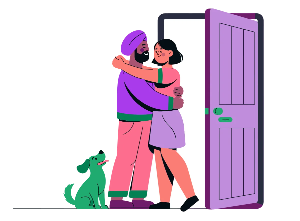 A couple hugging hello just inside their front door, with a little dog at their feet