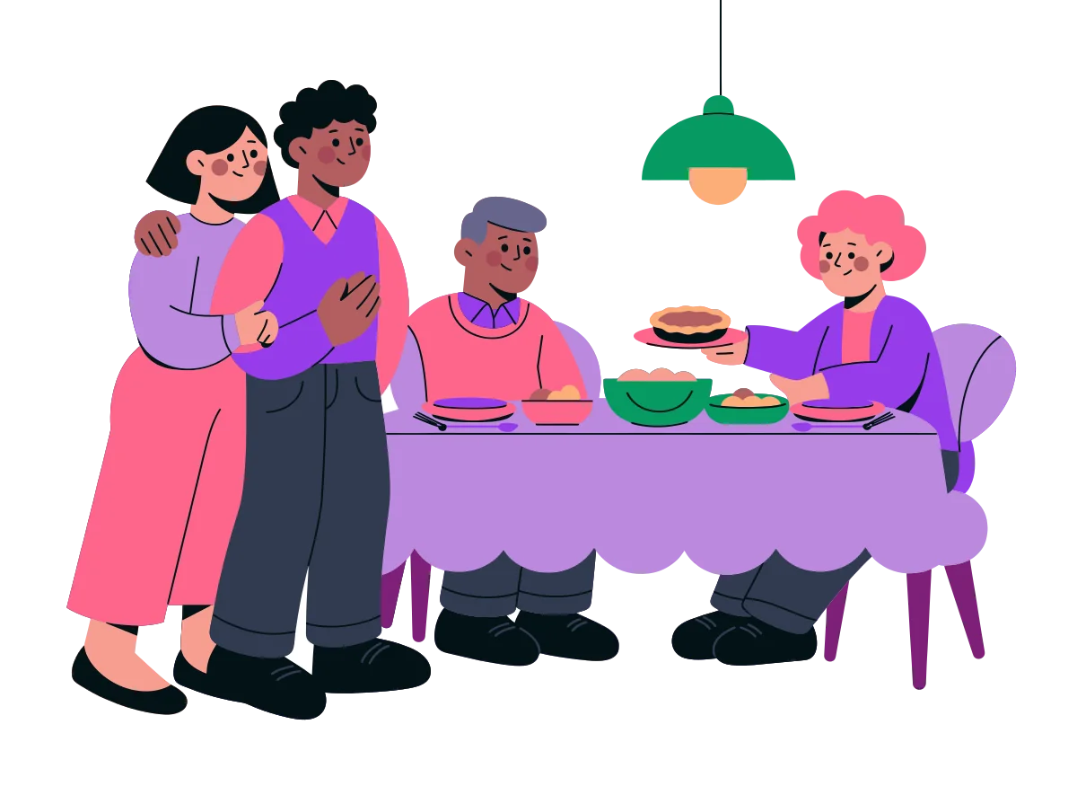 A couple standing arm in arm beside a family dinner table where two older relatives sit, one holding out a pie
